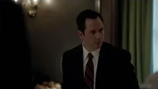 man in suit sitting at desk in dim room — Suits