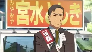man in suit speaking into microphone — Your Name