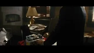 Man in suit standing by window — Now You See Me