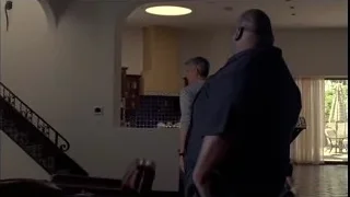 man in suit walking up living room staircase — Breaking Bad