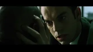 man in suit with hand on chin thinking — The Matrix