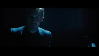 Man in suit with serious expression in dark room — La La Land