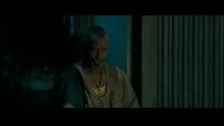 Man in traditional outfit in dimly lit room — Gladiator 2