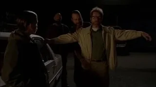 man in trench coat walking to car — Breaking Bad