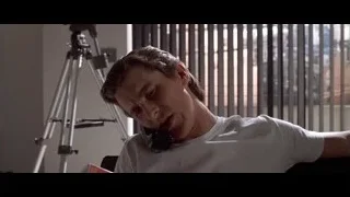 Man on couch talking on phone — American Psycho