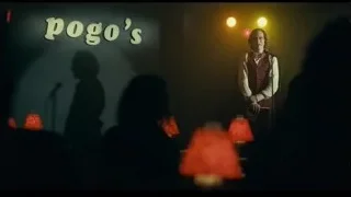man singing on stage with microphone — Joker