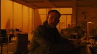 man sitting at table deep in thought — Blade Runner 2049