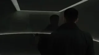 man standing in dimly lit room with curved ceiling — Blade Runner 2049