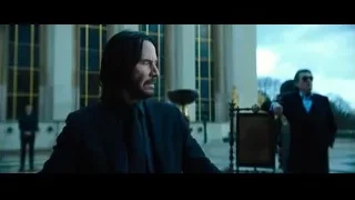man standing in front of large building — John Wick: Chapter 4