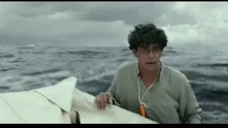 Man standing on boat in choppy ocean — Life of Pi