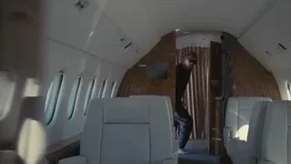 man walking down airplane aisle — Succession