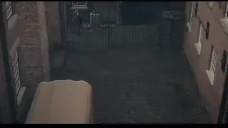 man walking on cobblestone street towards gate — Peaky Blinders