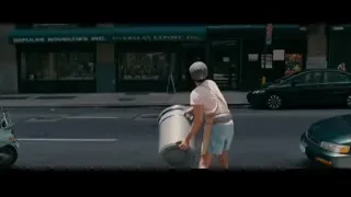 man walking on street with object — The Dictator
