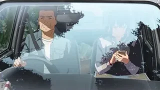 Man with beard pointing in car with woman — Your Name