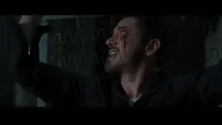 man with bloodied face in dark room — Iron Man 3
