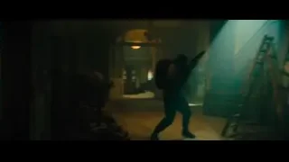 Man with gun in abandoned room with doorway — John Wick: Chapter 4