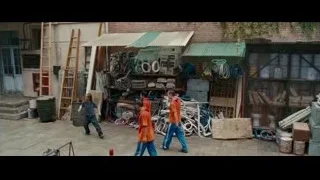 men in orange shirts walking on street — The Karate Kid