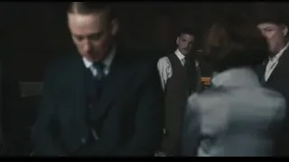 men in suits standing in dimly lit room — Peaky Blinders