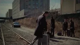 Men in suits standing on railway track — Succession