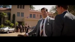 Men in suits talking by vintage car at building — Ford v Ferrari