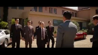 Men in suits walking in courtyard with red car — Ford v Ferrari