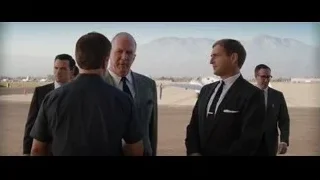 Men in suits walking on airport tarmac — Ford v Ferrari