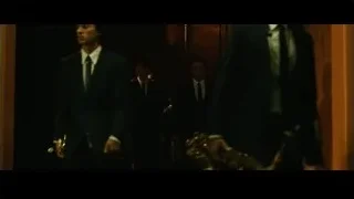 Men in suits with saxophone in hallway — Whiplash