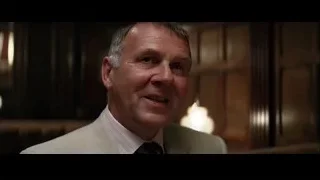 middle-aged man in suit in dimly lit room — Batman