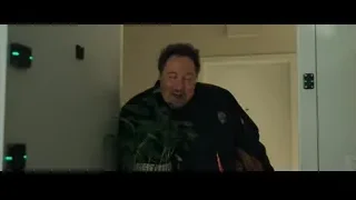middle-aged man smiling with potted plant in hallway — Spiderman: No Way Home