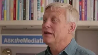 Older man by bookshelf with 'AsktheMedia' sign — Screened Out