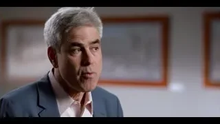older man in blue blazer smiling — The Social Dilemma