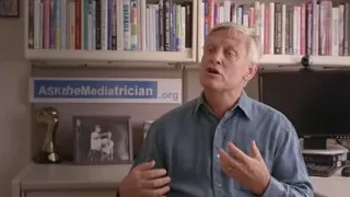 older man speaking in front of bookshelf — Screened Out