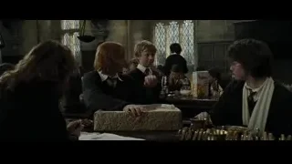 People around table with gift box — Harry Potter and the Goblet of Fire
