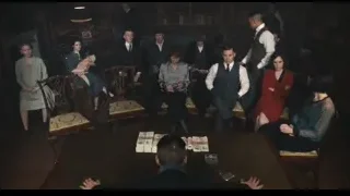 people around table with man clasping hands — Peaky Blinders