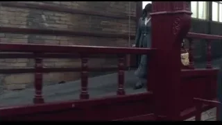 people on red staircase with large windows — Peaky Blinders