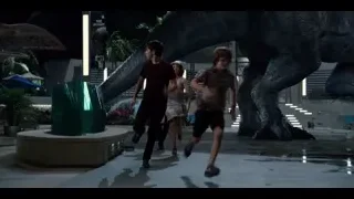 people running towards large dinosaur — Jurassic World