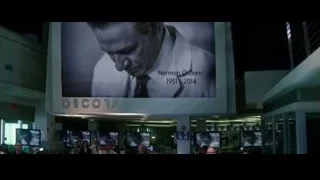 people standing in front of Oscorp screen — The Amazing Spider Man 2