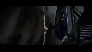 Person hanging from rope in dark tunnel — Bruce Lee: Enter The Dragon