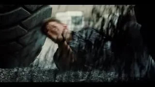 Person lying under car on gravel road — Jurassic World