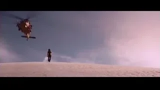 Person on sand dune watching helicopter fly — Iron Man