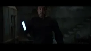 Person performing skateboard trick in dark room — Iron Man 3