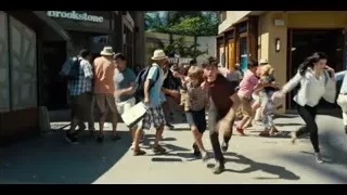 person performing trick on platform for crowd — Jurassic World