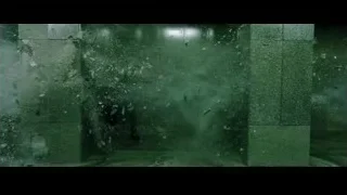 Person with gun in dark, wet, concrete room — The Matrix