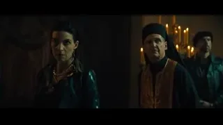 priest and woman in dimly lit room — John Wick: Chapter 4