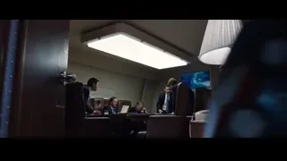 robot in black suit standing in a room — Iron Man 3