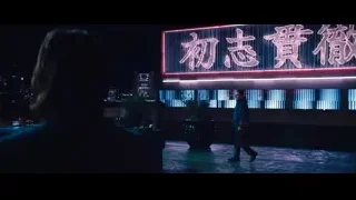rooftop restaurant at night with neon Chinese sign — John Wick: Chapter 4