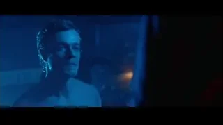 Shirtless man in dimly lit room with blue light — John Wick