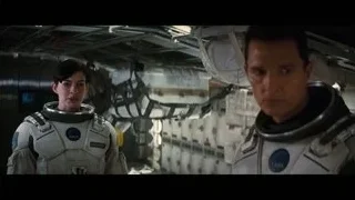 Two astronauts in spacesuits in space station — Interstellar