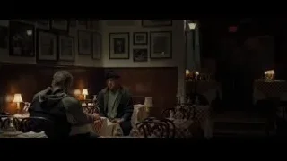 two men at table in dimly lit dining room — Creed 2