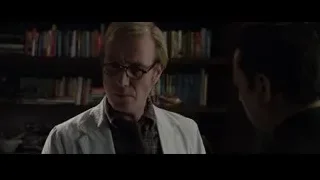 Two men in lab coats in room with bookshelves — The Amazing Spider Man